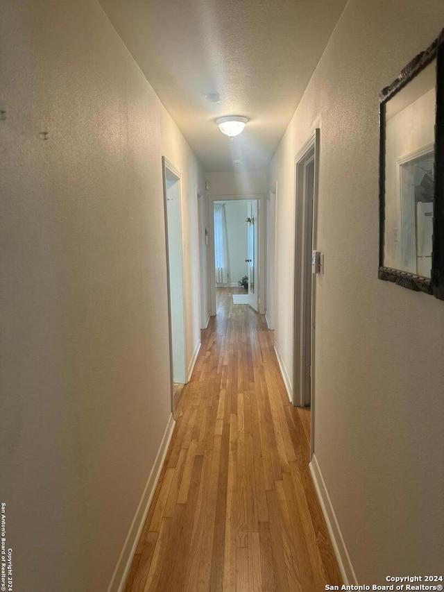 corridor featuring light hardwood / wood-style floors