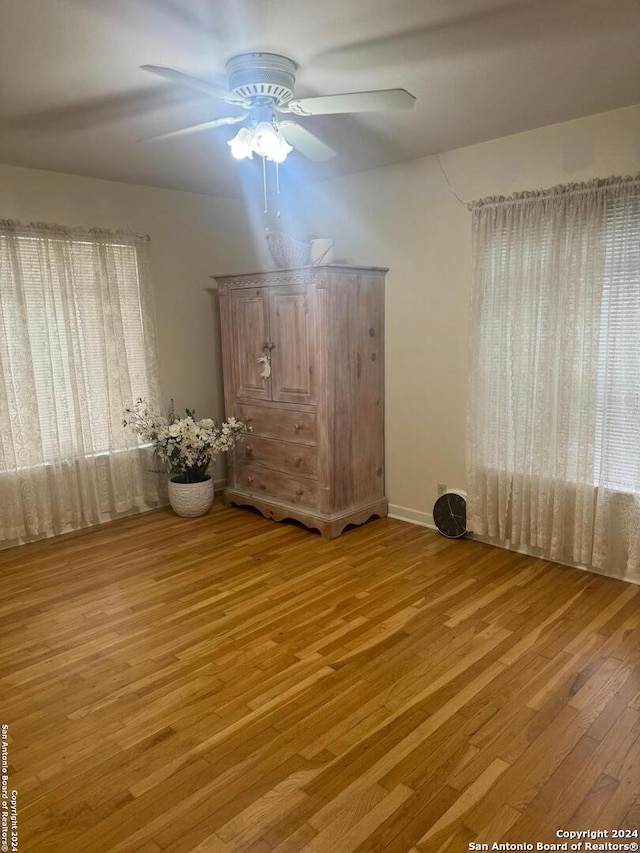 interior space with light hardwood / wood-style flooring and ceiling fan