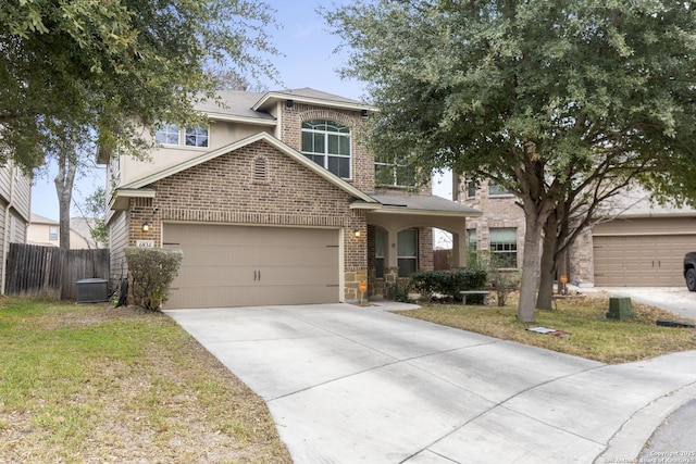 view of front of house with central AC, a garage, and a front yard