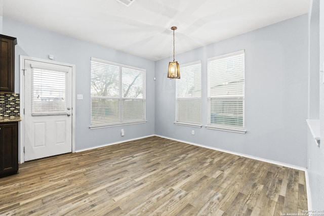 unfurnished dining area featuring hardwood / wood-style floors