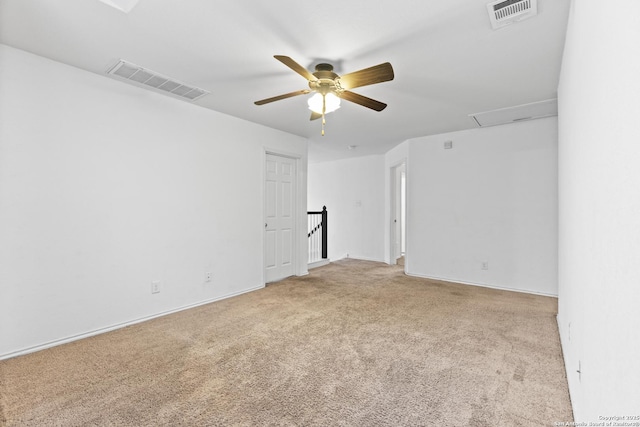 unfurnished room featuring light colored carpet and ceiling fan