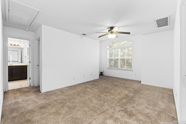 carpeted spare room featuring ceiling fan