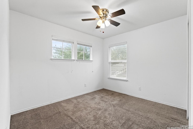 carpeted spare room featuring ceiling fan