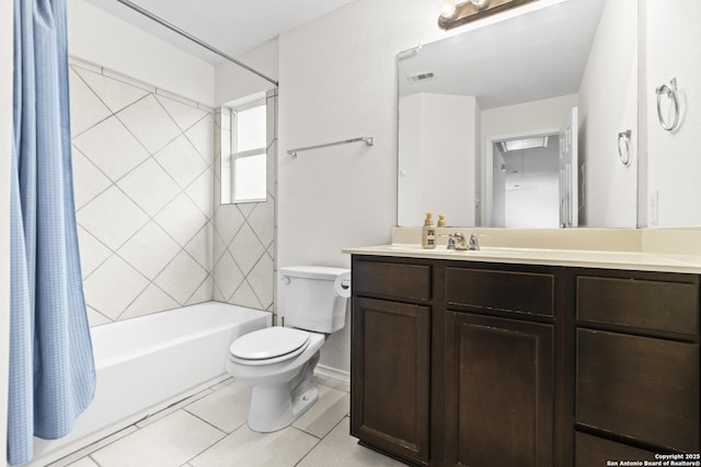 full bathroom featuring tile patterned floors, vanity, toilet, and shower / bath combo with shower curtain