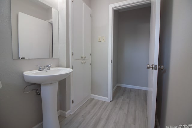 bathroom with sink and hardwood / wood-style flooring