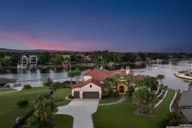 aerial view at dusk with a water view