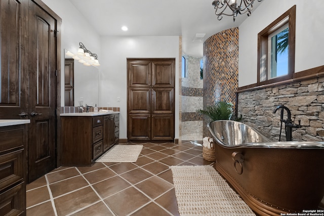 bathroom with vanity, a shower, tile patterned floors, and a chandelier