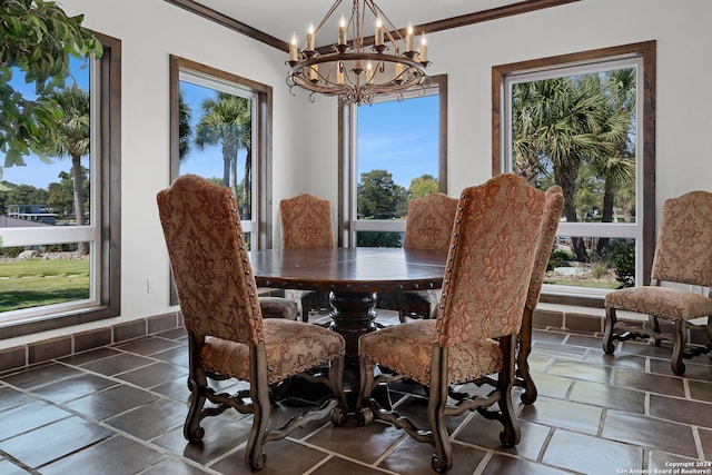 dining space featuring ornamental molding, a chandelier, and plenty of natural light