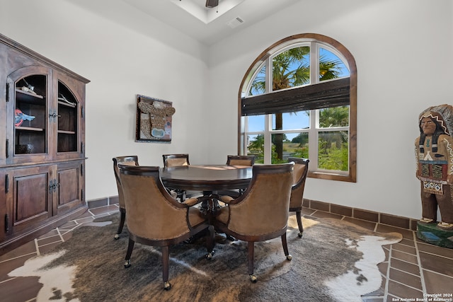 tiled dining space with a high ceiling