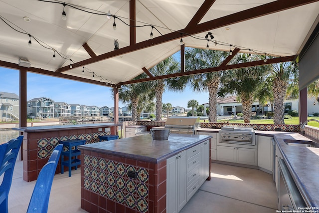 view of patio / terrace with area for grilling and a wet bar