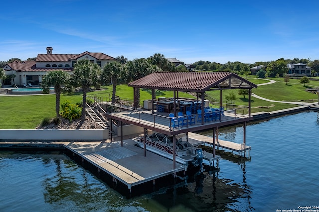 view of dock with a gazebo, a water view, and a lawn