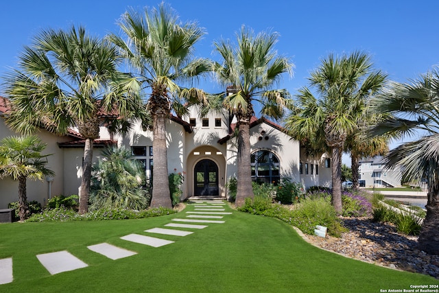 mediterranean / spanish-style house featuring a front yard