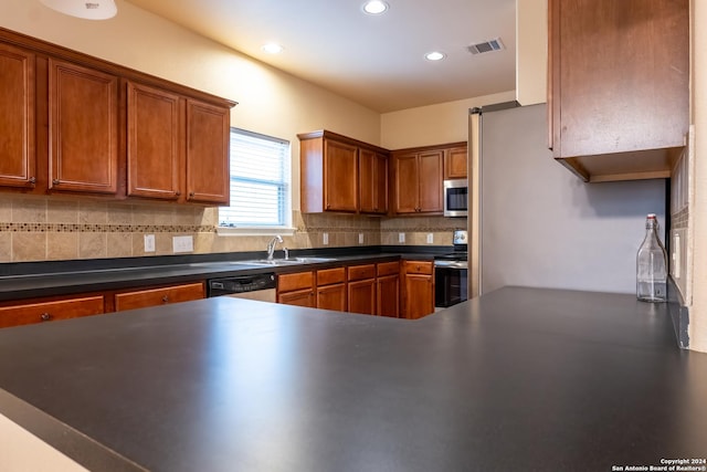 10707 Axis Xing, San Antonio, TX 78245 - kitchen featuring appliances with stainless steel finishes, tasteful backsplash, dark countertops, recessed lighting, and a sink