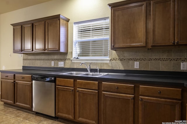 10707 Axis Xing, San Antonio, TX 78245 - kitchen with stainless steel dishwasher, a sink, dark countertops, backsplash, and light tile patterned flooring