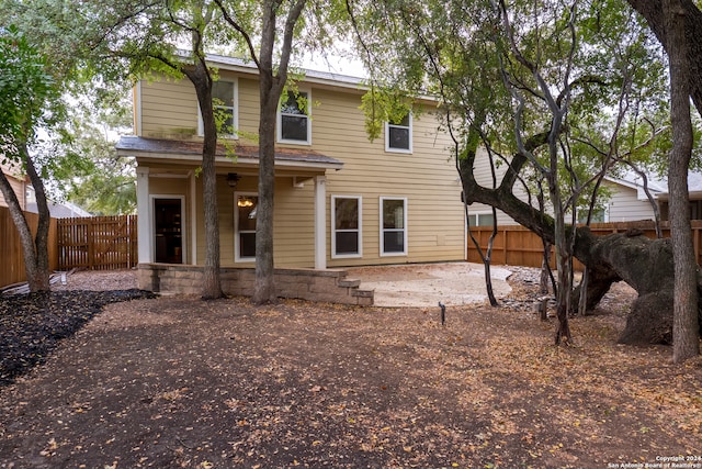 back of property with a patio