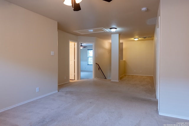 carpeted spare room featuring ceiling fan