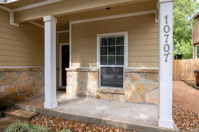 10707 Axis Xing, San Antonio, TX 78245 - doorway to property with stone siding and fence