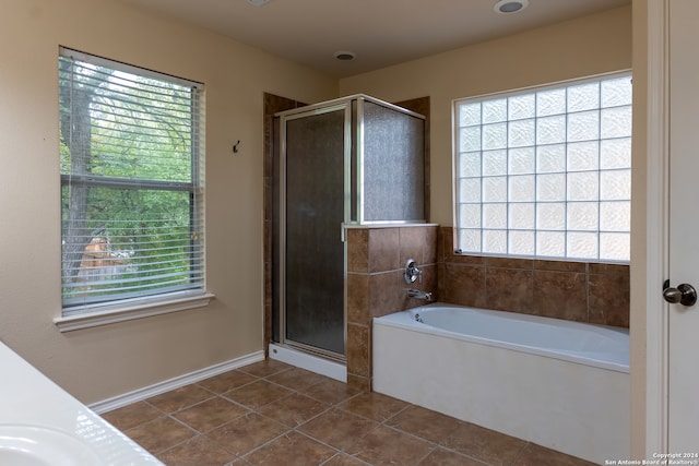 bathroom with independent shower and bath and plenty of natural light