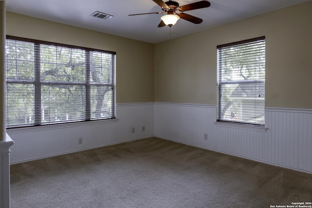 10707 Axis Xing, San Antonio, TX 78245 - empty room with wainscoting, plenty of natural light, carpet flooring, and a ceiling fan