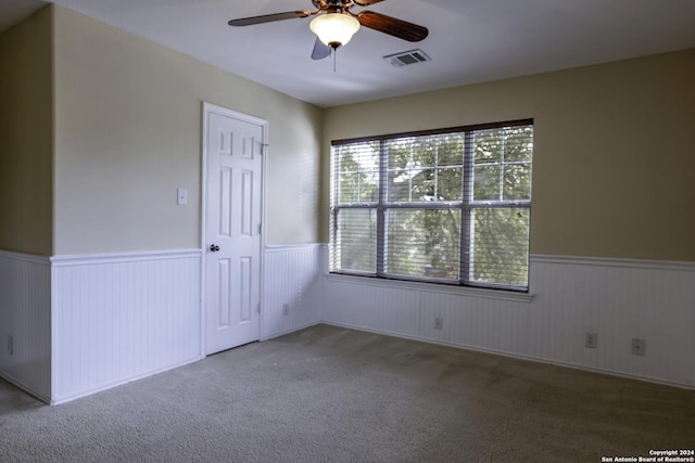10707 Axis Xing, San Antonio, TX 78245 - unfurnished room with ceiling fan, a wainscoted wall, and carpet