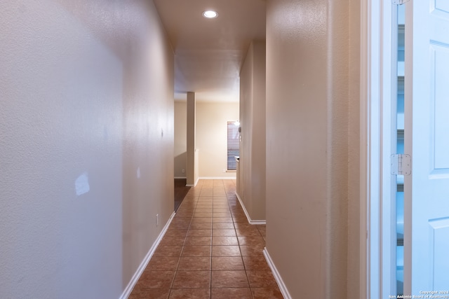 hallway with dark tile patterned floors