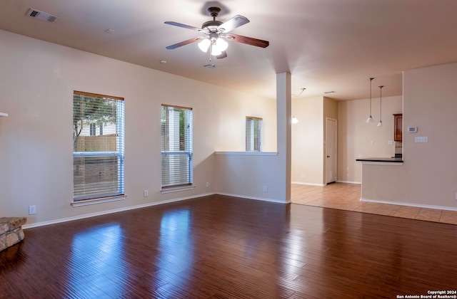 unfurnished living room featuring hardwood / wood-style flooring and ceiling fan