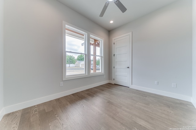 unfurnished room with ceiling fan and light hardwood / wood-style floors