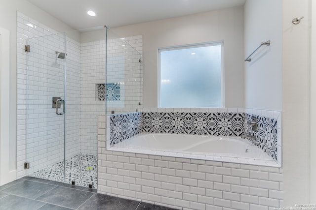 bathroom featuring plus walk in shower and tile patterned flooring