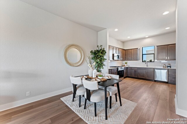 dining area with sink and hardwood / wood-style floors