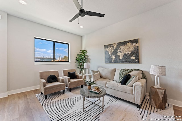 living room with light wood-type flooring and ceiling fan