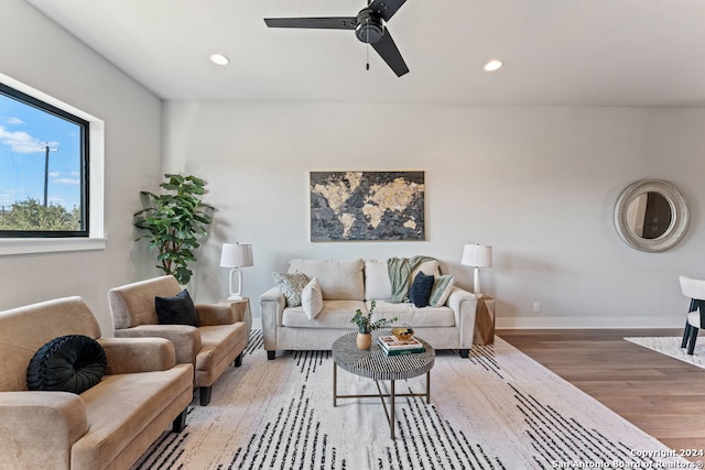 living room with wood-type flooring and ceiling fan