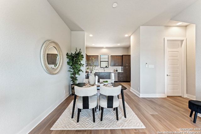 dining area featuring sink and light hardwood / wood-style flooring