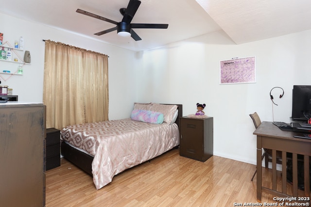 bedroom with ceiling fan and hardwood / wood-style flooring