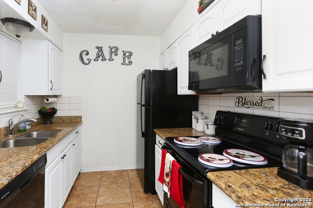 kitchen featuring white cabinetry and black appliances