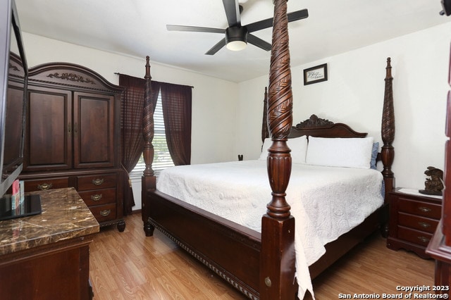 bedroom with light hardwood / wood-style flooring and ceiling fan