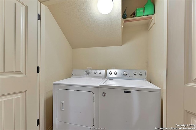 washroom featuring washer and dryer and a textured ceiling