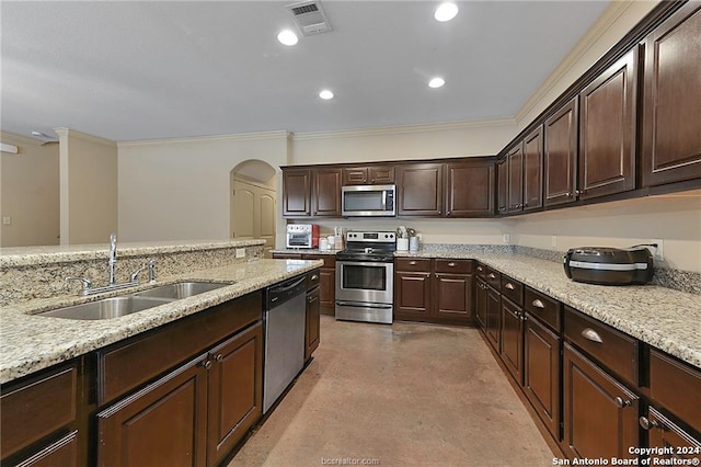 kitchen with sink, appliances with stainless steel finishes, dark brown cabinetry, and crown molding