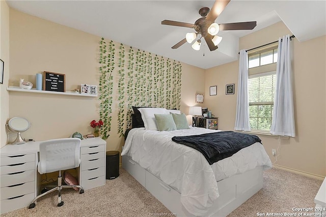 bedroom featuring ceiling fan and light carpet