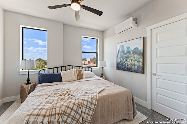 bedroom with a wall mounted AC, carpet floors, and ceiling fan