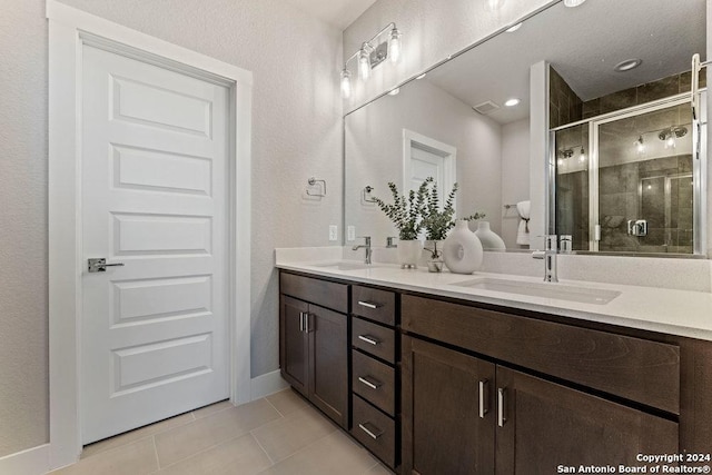 7942 Kennedy Hl Unit 8, San Antonio, TX 78235 - full bath with a shower stall, tile patterned floors, toilet, double vanity, and baseboards
