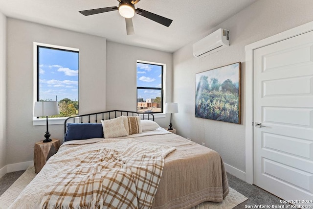 7942 Kennedy Hl Unit 8, San Antonio, TX 78235 - bedroom featuring a wall mounted AC, baseboards, and a ceiling fan