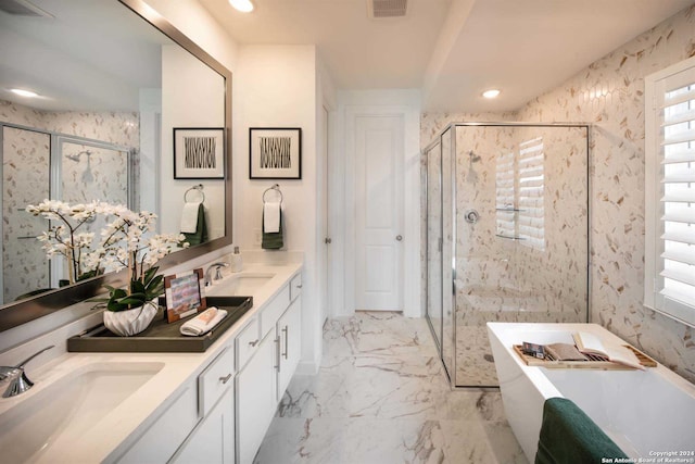 bathroom featuring vanity and independent shower and bath