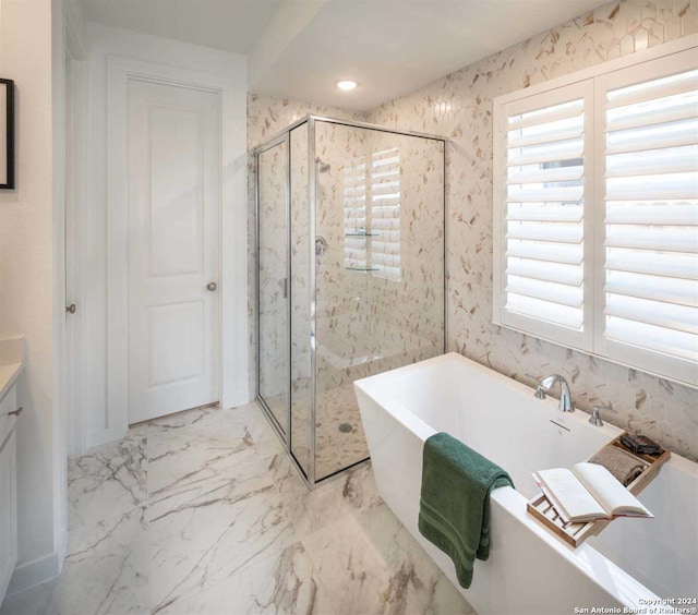 bathroom featuring independent shower and bath and vanity