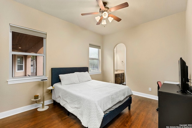 bedroom with dark wood-type flooring, ceiling fan, and ensuite bathroom