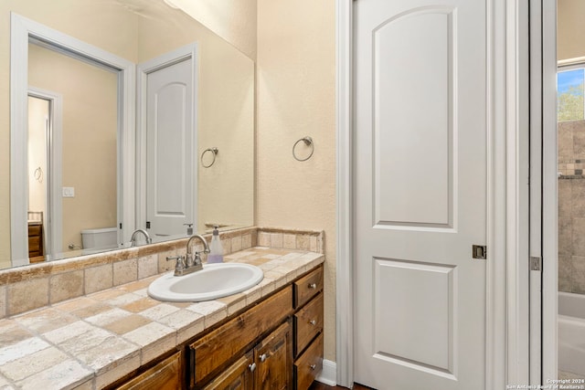 bathroom featuring vanity and toilet