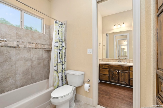 full bathroom featuring vanity, hardwood / wood-style flooring, toilet, and shower / tub combo