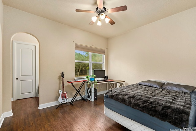 bedroom with dark wood-type flooring and ceiling fan