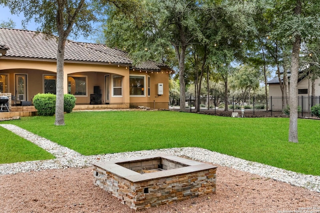 view of yard with a fire pit