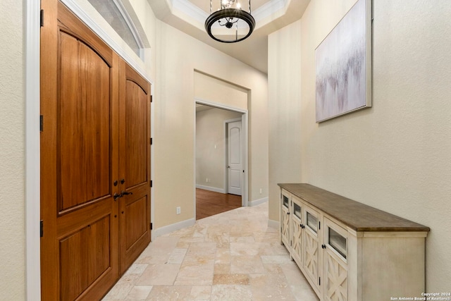 foyer featuring a raised ceiling