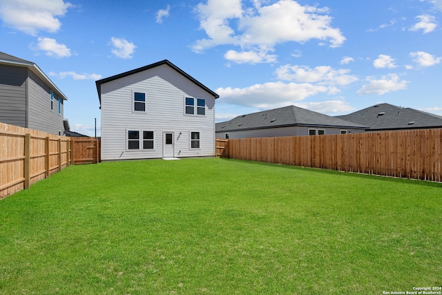 back of house featuring a yard